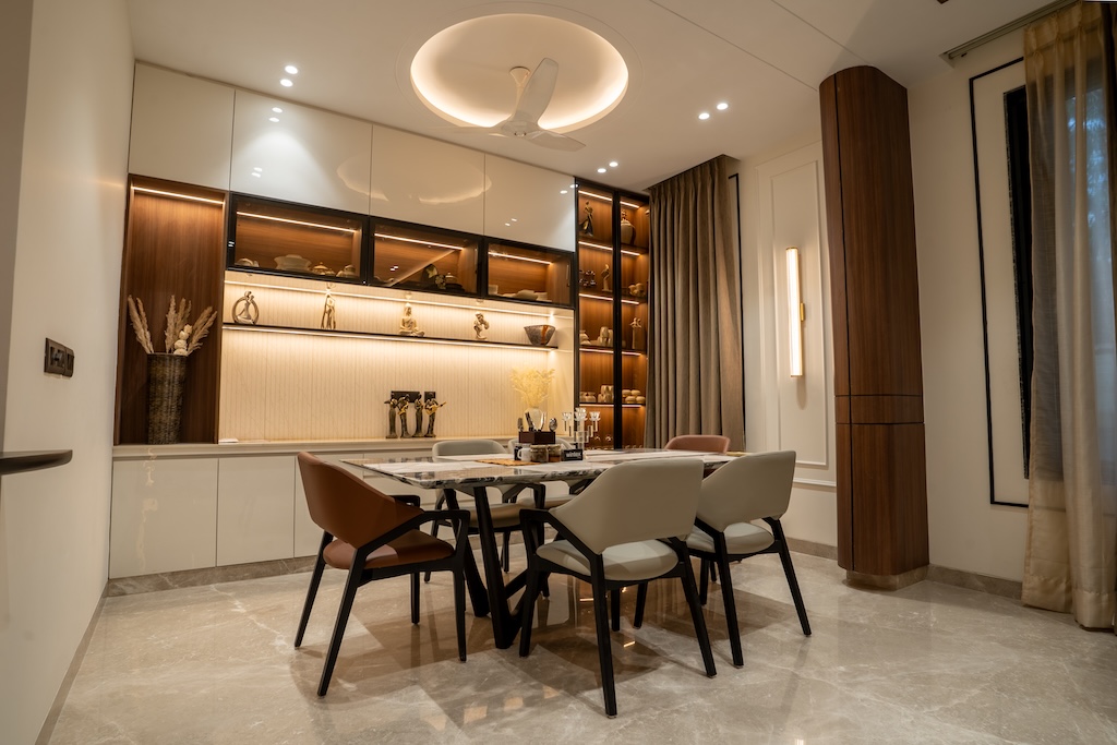 ZuildUp interior — dining area with marble-top table and backlit display cabinetry