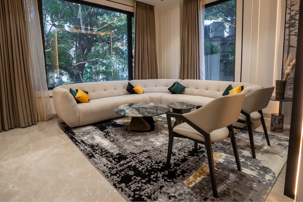 ZuildUp interior — living room with corner windows, marble floors and minimalist styling