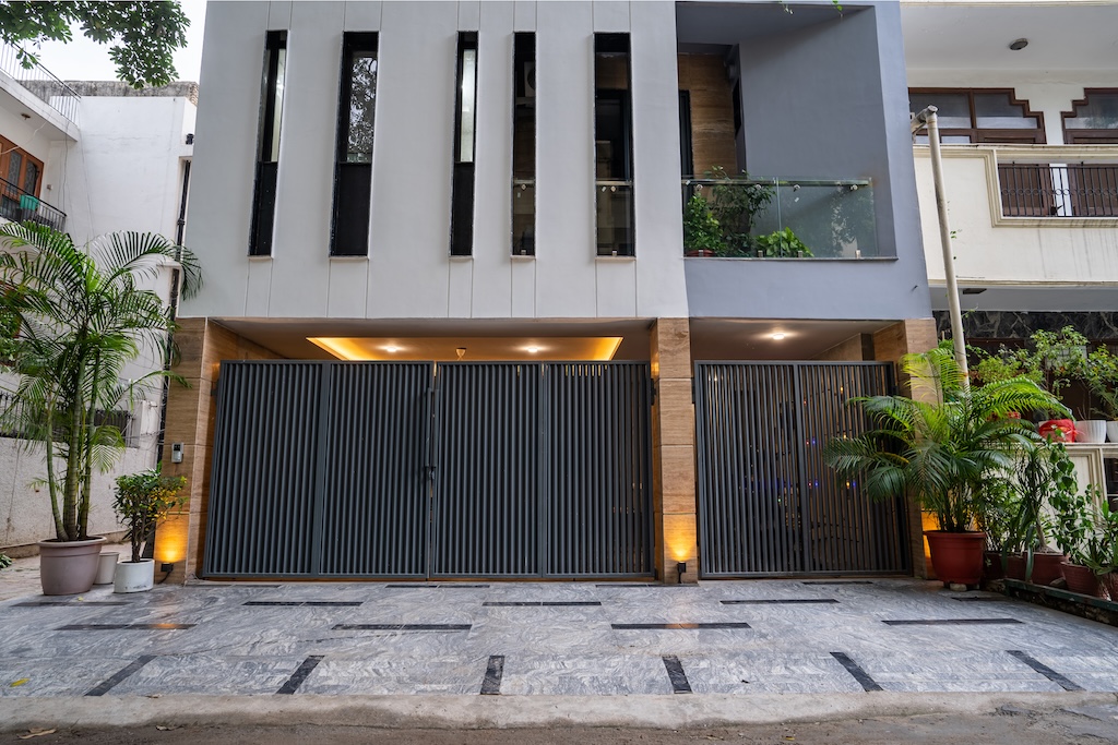 ZuildUp project — modern entrance with slatted metal gates and wood portal